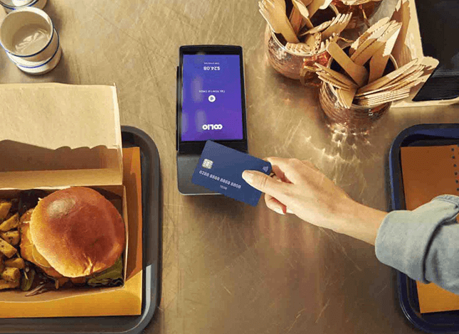 Customer tapping card on Oolio Pay device for Bepoz